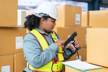 Worker using a product scanner in a warehouse